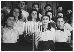 Choir in Landsberg DP camp, c. 1947. Two of the young women pictured are Nechama Santocki (later Shneorson) and Reva Sidrer (later Baran). They are the aunts of PHA board member Ettie Zilber; they donated this photo to USHMM.